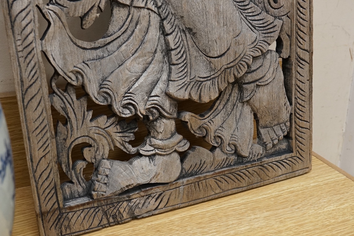 An Asian or Thai carved panel of a deity, 90cm high